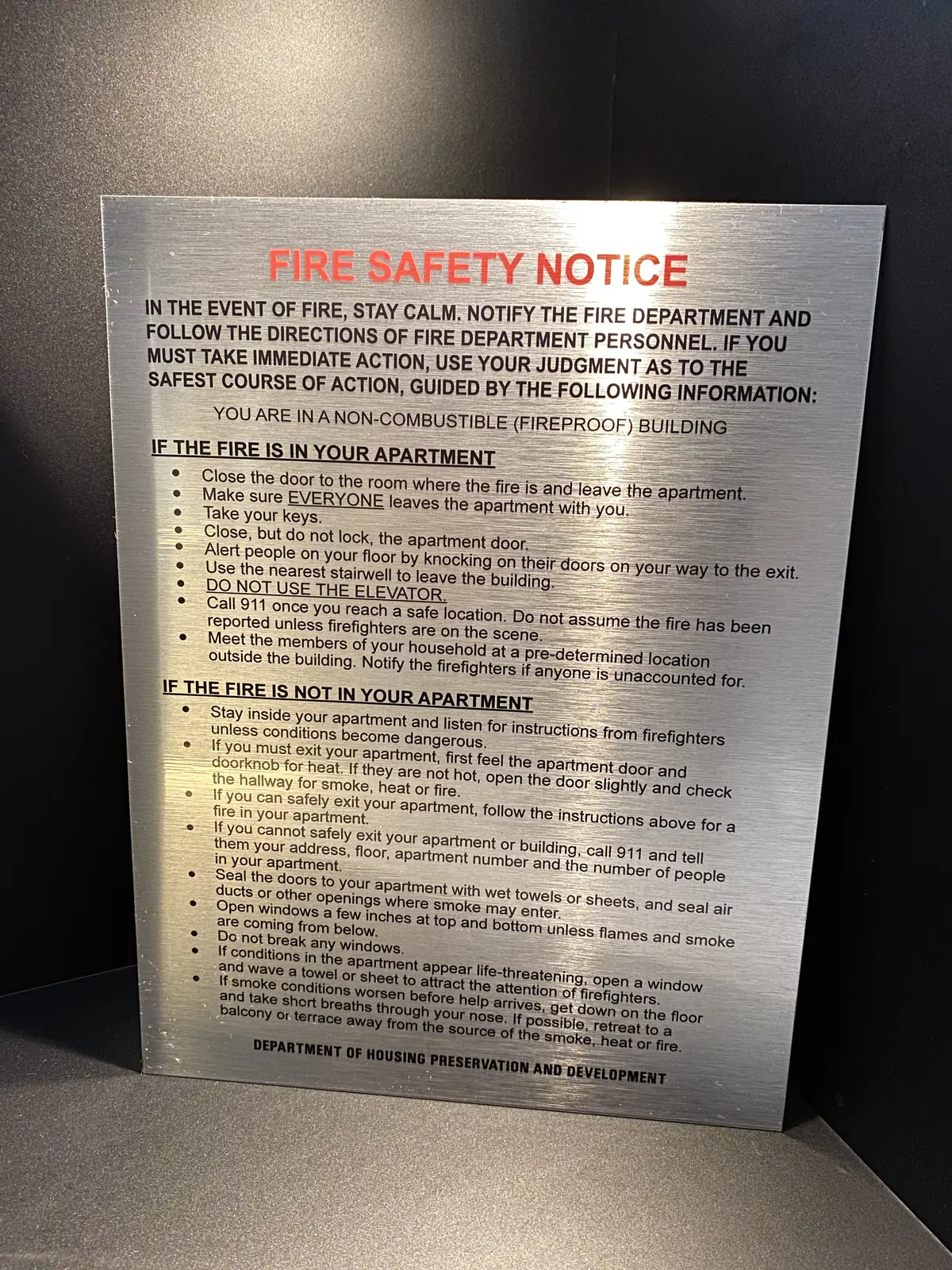 FDNY fire safety notice printed on brushed aluminum