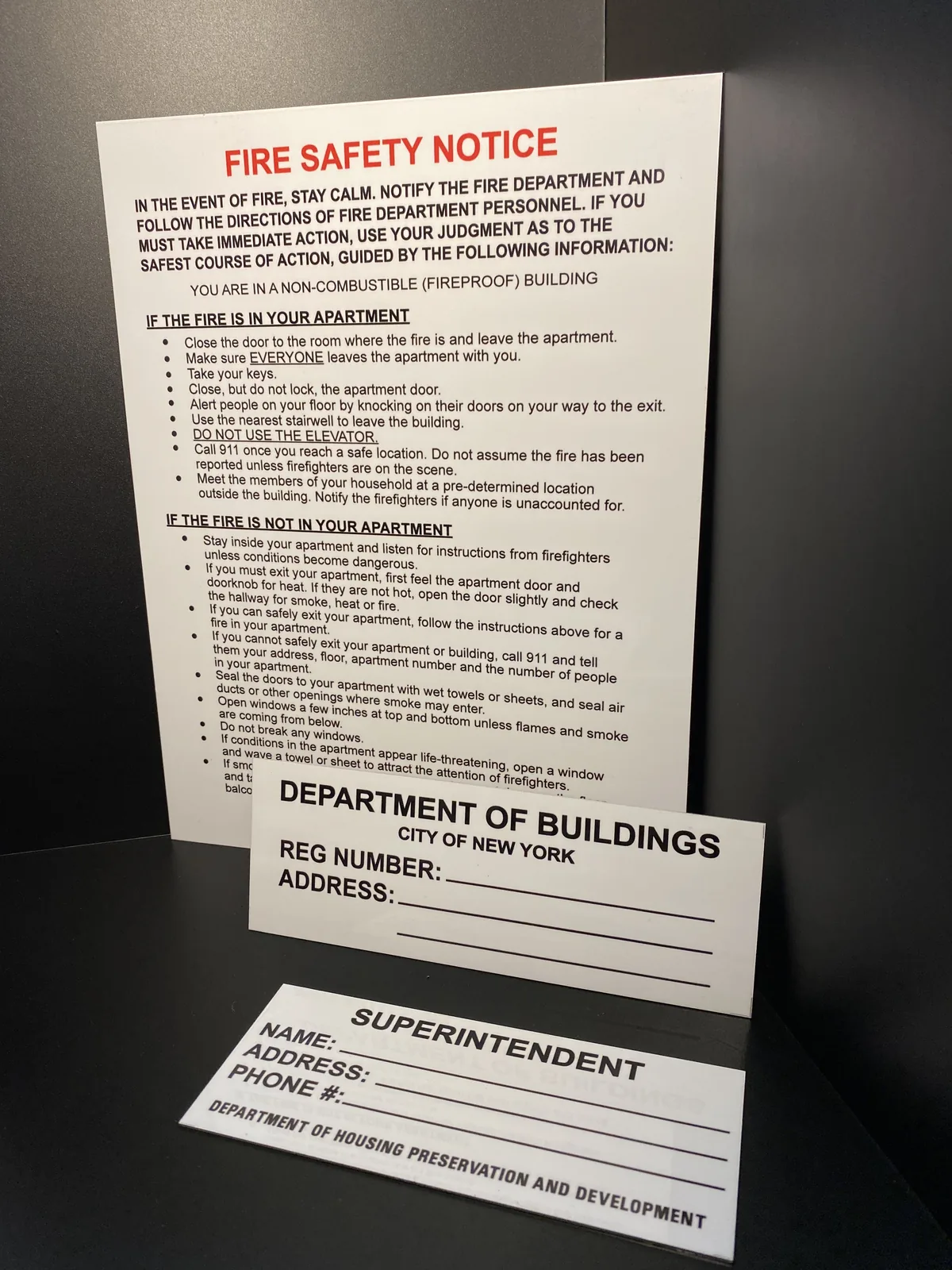 Fire safety notice with registration number and superintendent signs