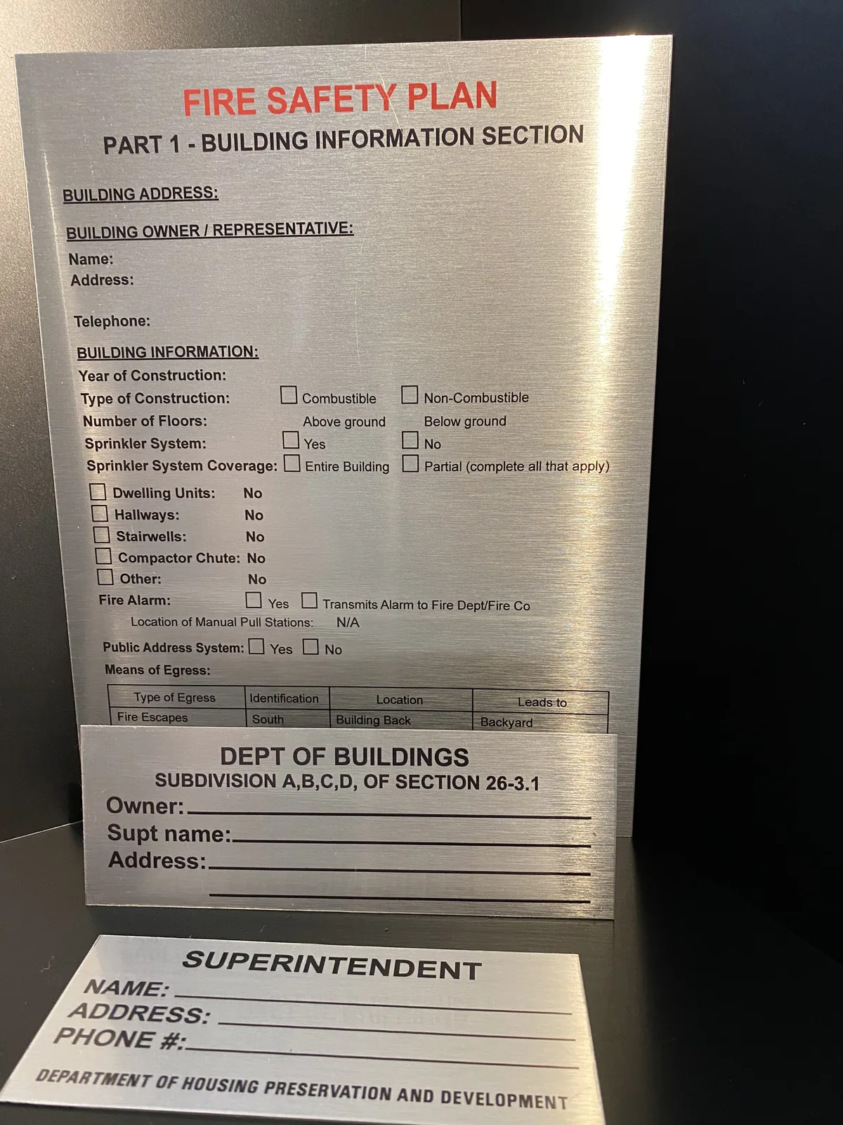 Brushed aluminum fire safety plan, Department of Buildings and superintendent signs